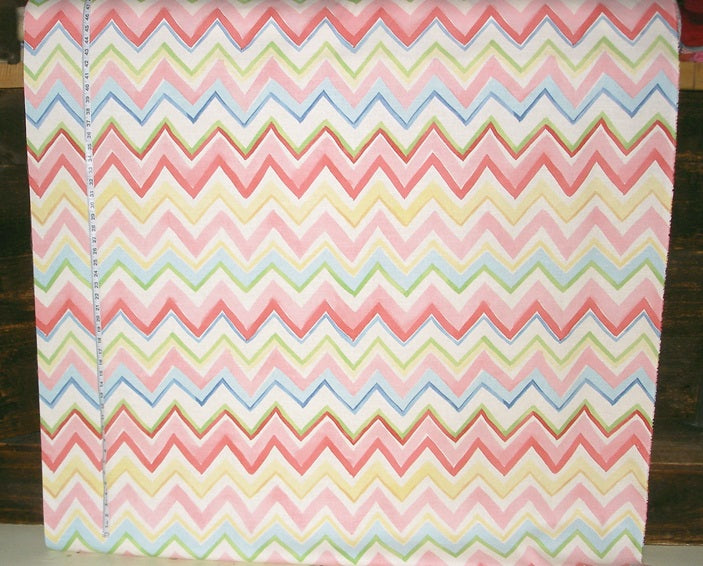 Fabric with colorful zigzag pattern on a wooden surface