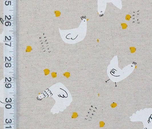 Pattern of white chickens and yellow chicks on a beige background with a ruler for scale.