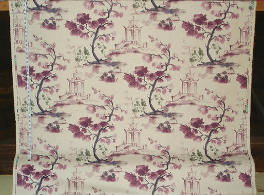 Fabric with floral and architectural pattern on a wooden surface