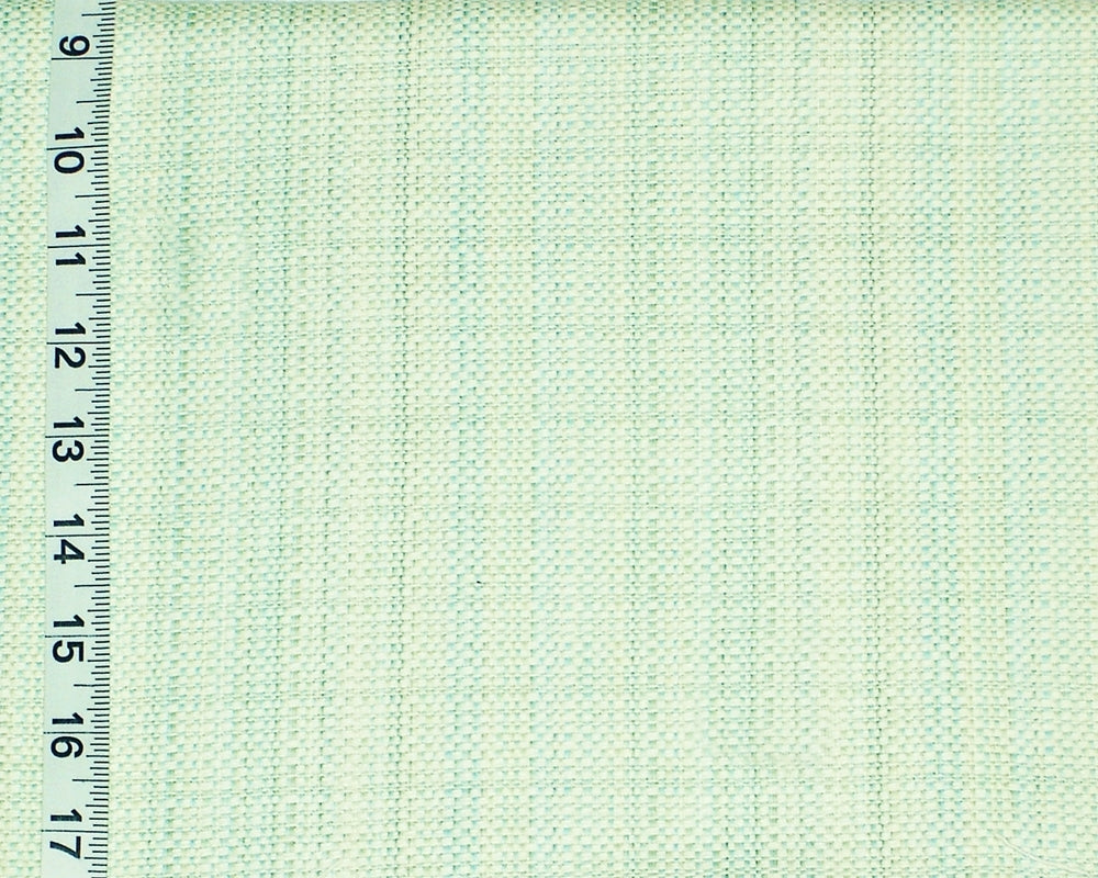 Textured green fabric with a ruler on the left side