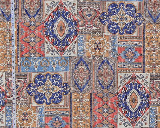 A close-up of a fabric or wallpaper pattern featuring a patchwork of traditional oriental and Persian-style motifs in blue, red, beige, and orange, with a white ruler on the left side showing the 12-inch scale.