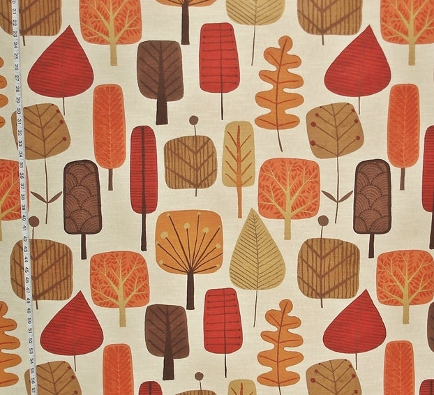 Fabric with a pattern of stylized trees in red, brown, and orange on a beige background.