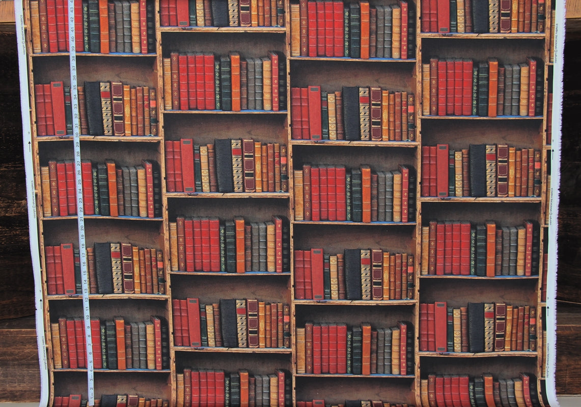 A roll of wallpaper or contact paper featuring a repeating pattern of wooden bookshelves filled with red, orange, and black vintage books, shown with a white measuring tape on the left side.