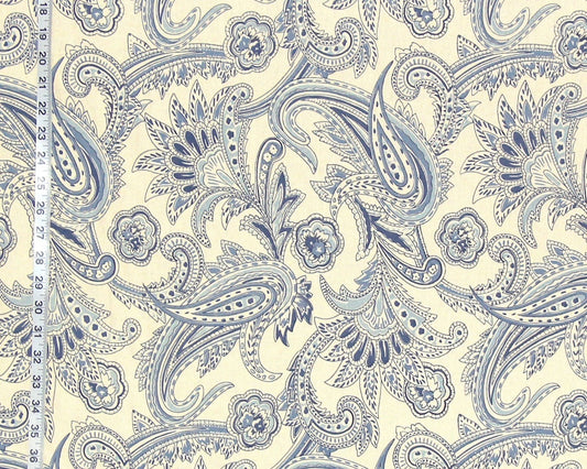 Blue paisley pattern on a beige background with a ruler for scale.