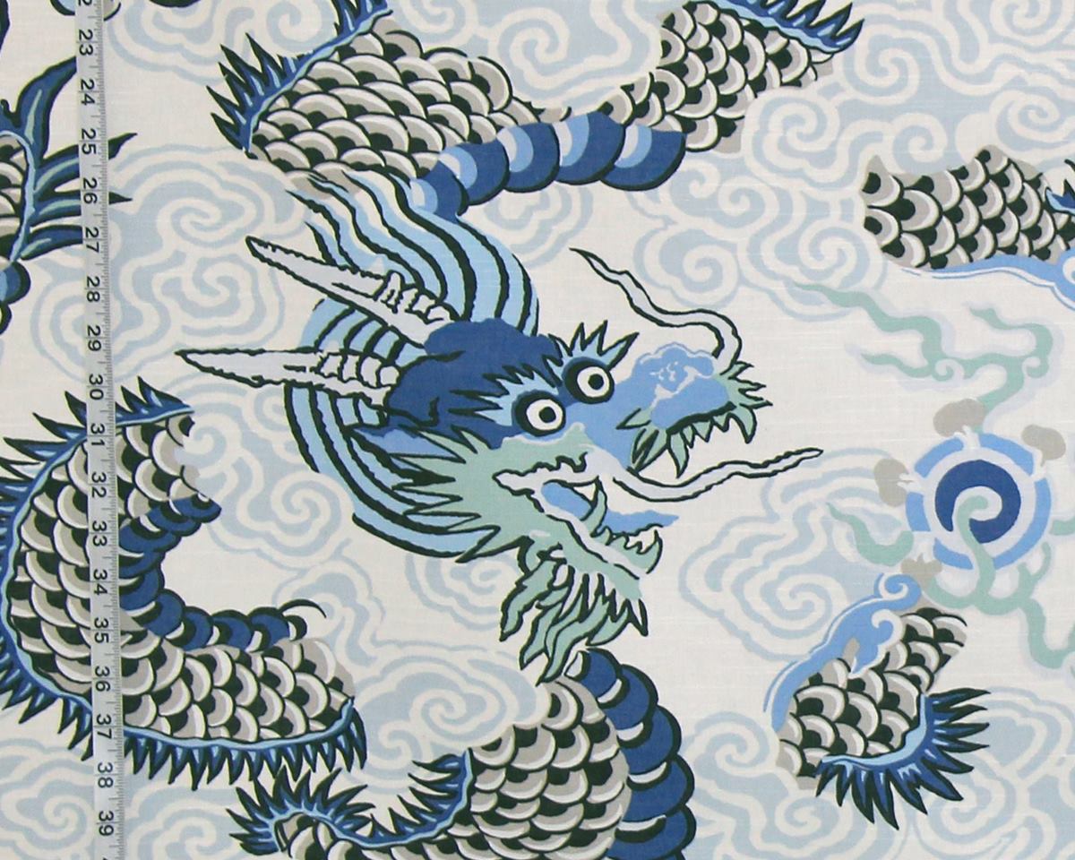 Fabric with blue and green dragon pattern on a white background