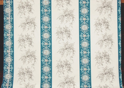 A close-up of a patterned fabric or wallpaper featuring vertical stripes with teal ornamental borders and a repeating beige floral toile motif on an off-white background.