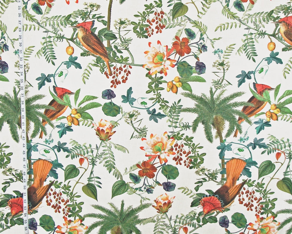 A close-up of a fabric or wallpaper pattern featuring a classic botanical and bird design. The print shows red-tailed birds, palm trees, berries, and flowers on a cream-colored background, with a white measuring tape visible on the left side to indicate scale.