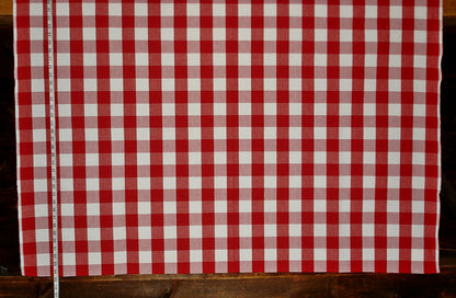 Red and white checkered fabric on a wooden surface