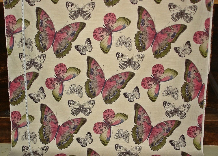 Fabric with a pattern of pink and green butterflies on a beige background