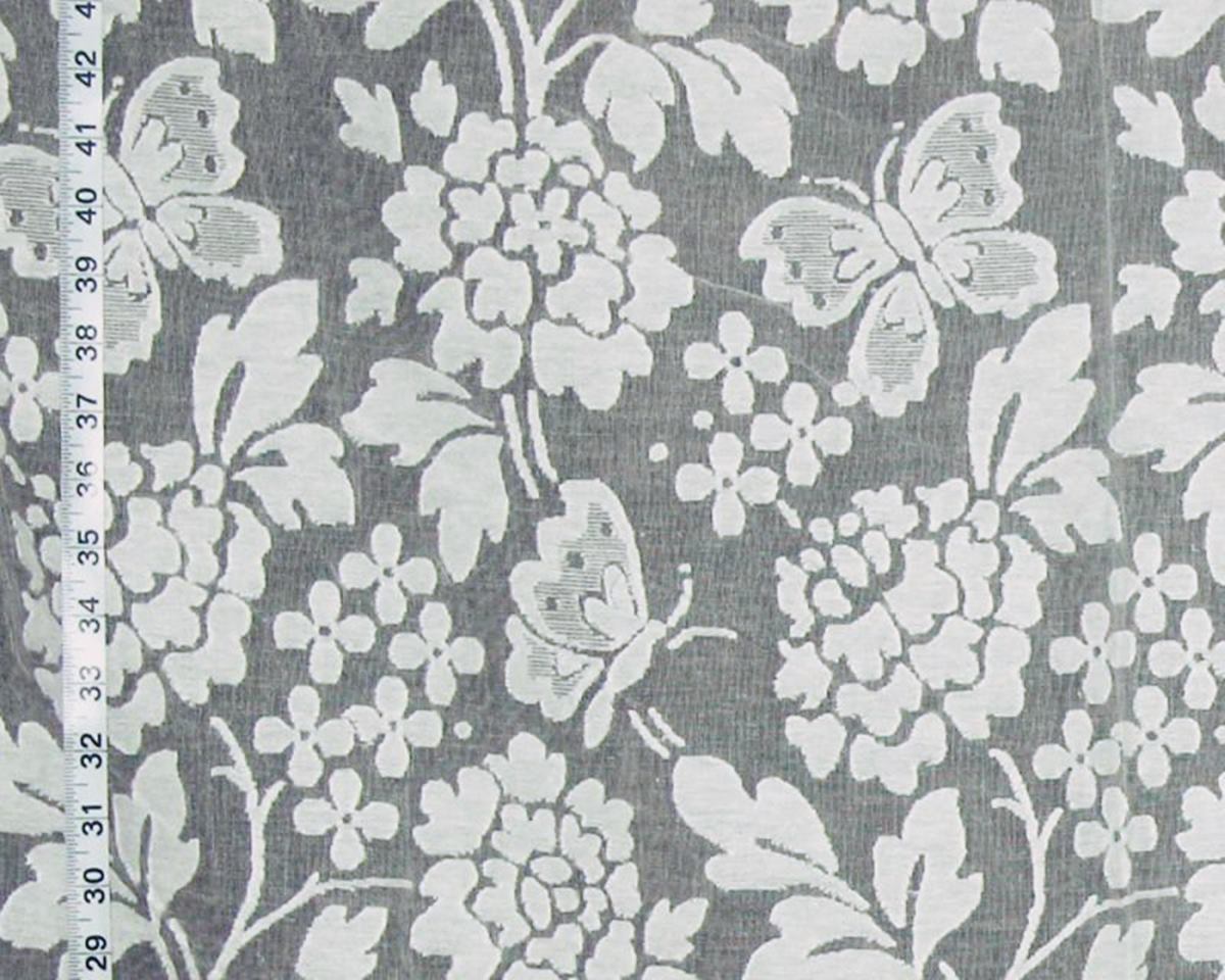 Gray and white floral fabric with butterflies and a measuring tape visible along the left edge.