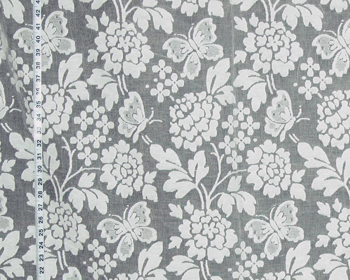 Gray fabric with a white floral and butterfly pattern, shown with a measuring tape along the left edge for scale.