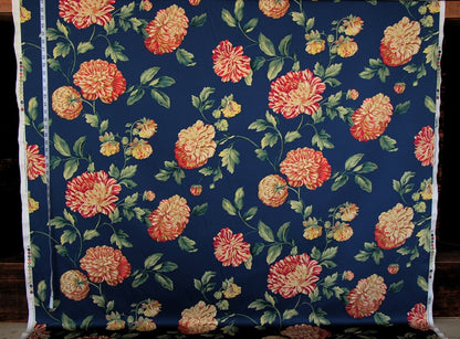 Floral fabric with orange and yellow flowers on a blue background