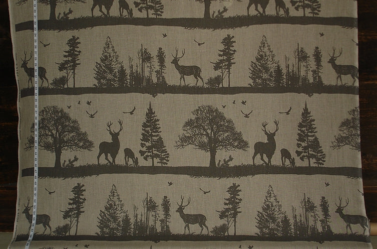 Fabric with deer and tree pattern on a beige background