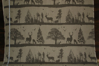 Fabric with deer and tree pattern on a beige background