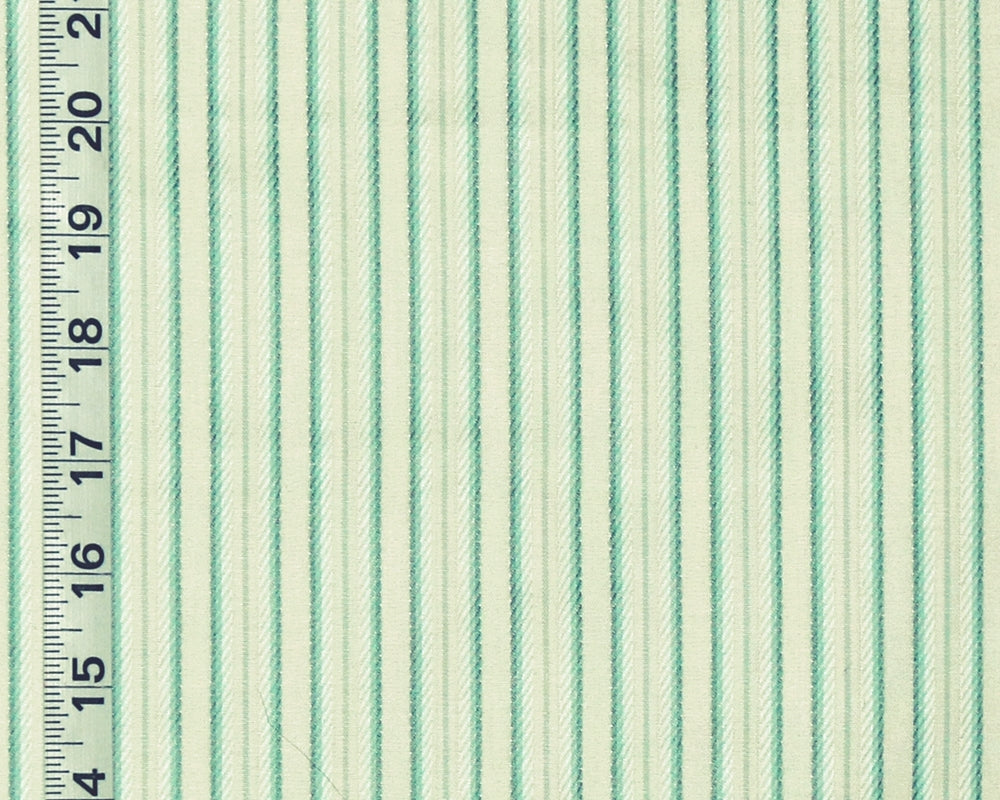 A close-up of striped fabric with alternating mint green and off-white vertical stripes, shown next to a black inch ruler for scale.
