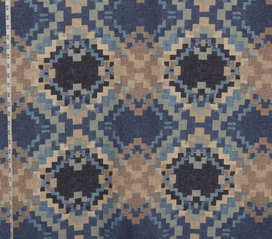 Patterned fabric with geometric design in blue and brown tones, shown with a ruler for scale.