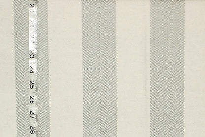 Textured fabric with horizontal stripes and a ruler for scale on a beige background