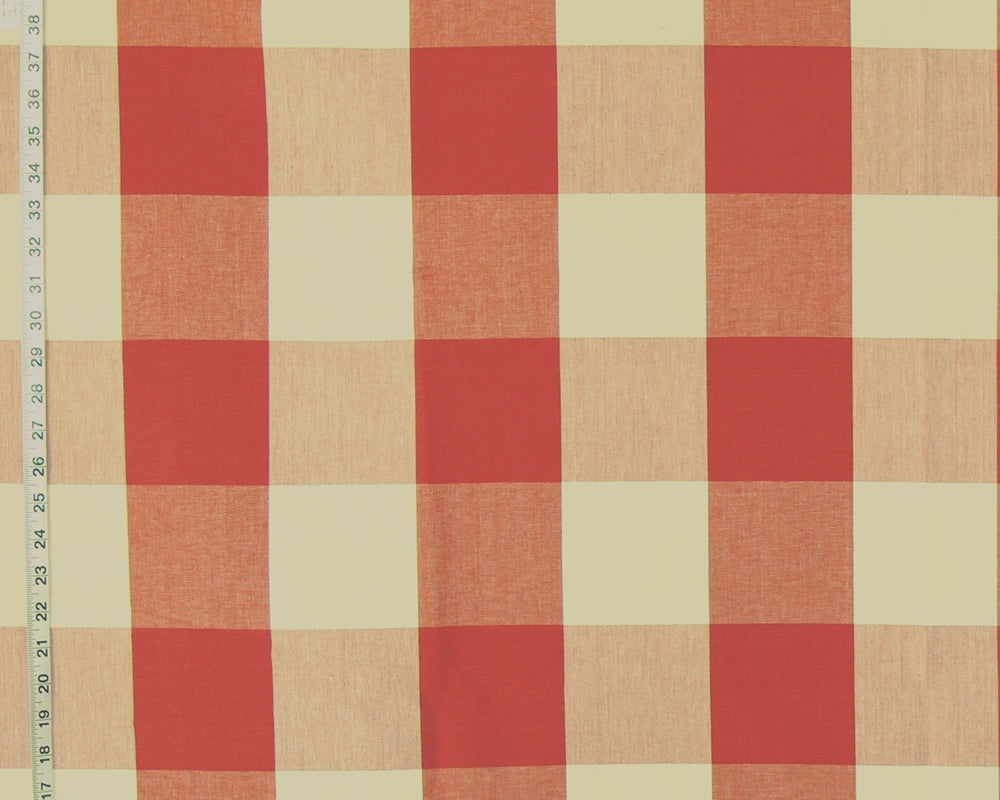 A close-up of a gingham checkered fabric pattern with alternating red and warm beige squares, shown with a measurement ruler along the left edge.