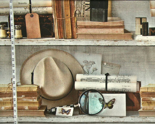 Vintage-style rustic shelf scene with stacked books, a straw hat, rolled papers, a magnifying glass, butterfly cards, and small decorative objects on weathered wooden shelves.