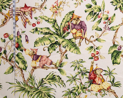 Fabric with monkey and leaf pattern, measured by a ruler.