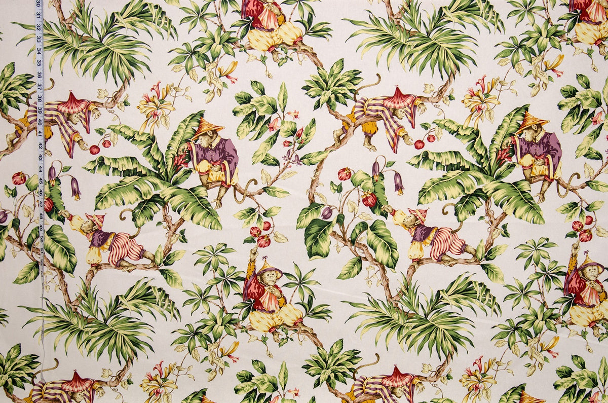 Tropical fabric pattern with monkeys, birds, and foliage on a beige background