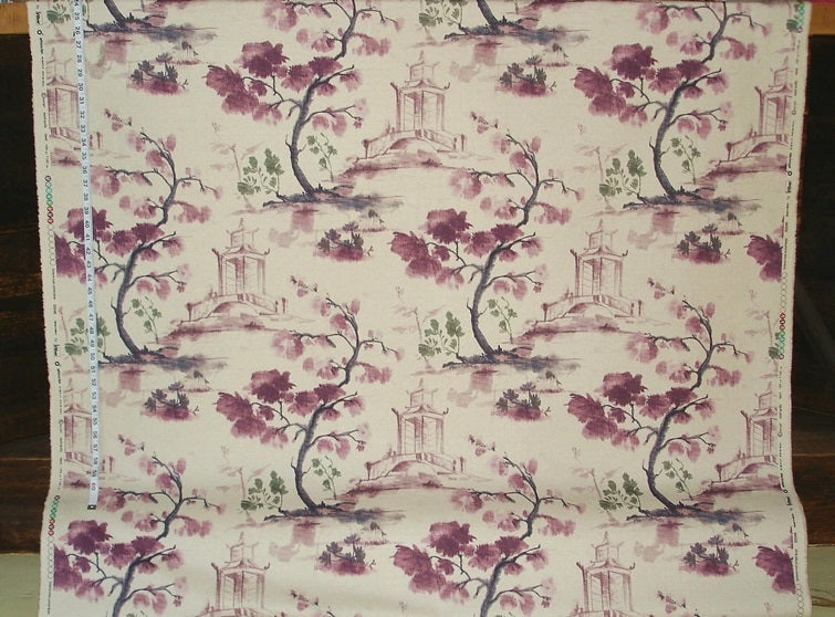Fabric with floral and architectural pattern on a wooden surface