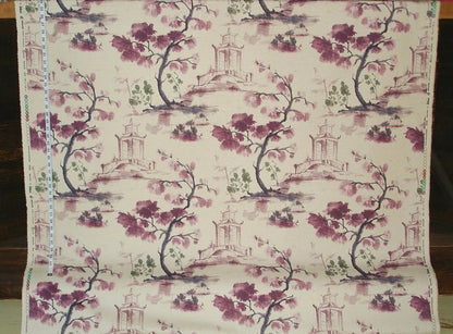 Fabric with floral and architectural pattern on a wooden surface