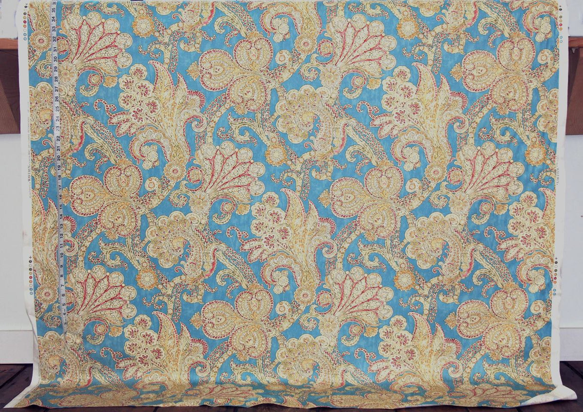 Decorative fabric with intricate paisley pattern on a blue background