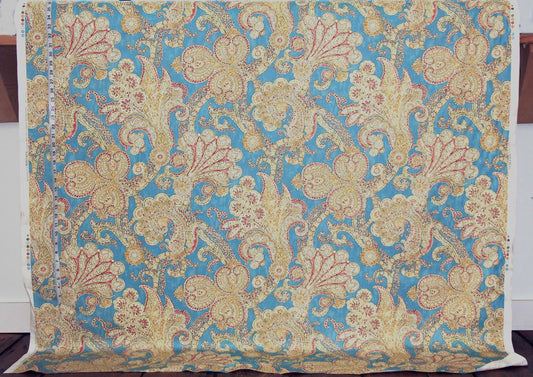 Decorative fabric with intricate paisley pattern on a blue background