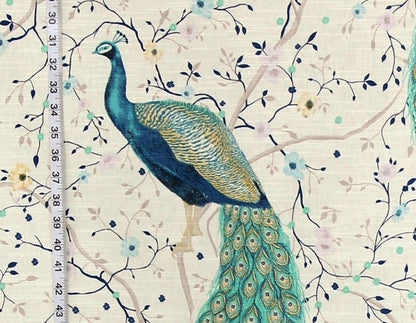 Peacock on a floral patterned fabric with a ruler for scale.