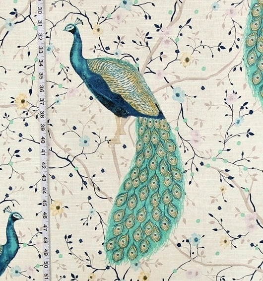 Peacock design on fabric with floral patterns and a ruler for scale.