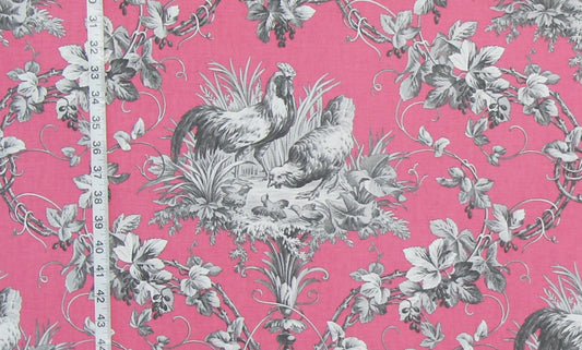 Pink fabric with a classic French Toile pattern featuring gray roosters, chickens, grapes, and leaves, shown with a white measuring tape on the left side.