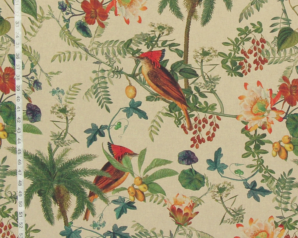 A close-up of a fabric or wallpaper pattern featuring two red-crowned birds among tropical leaves, flowers, and palm trees on a light beige background, with a white measuring ruler visible along the left edge.