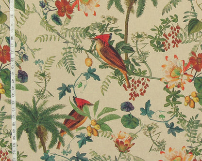 A close-up of a fabric or wallpaper pattern featuring two red-crowned birds among tropical leaves, flowers, and palm trees on a light beige background, with a white measuring ruler visible along the left edge.