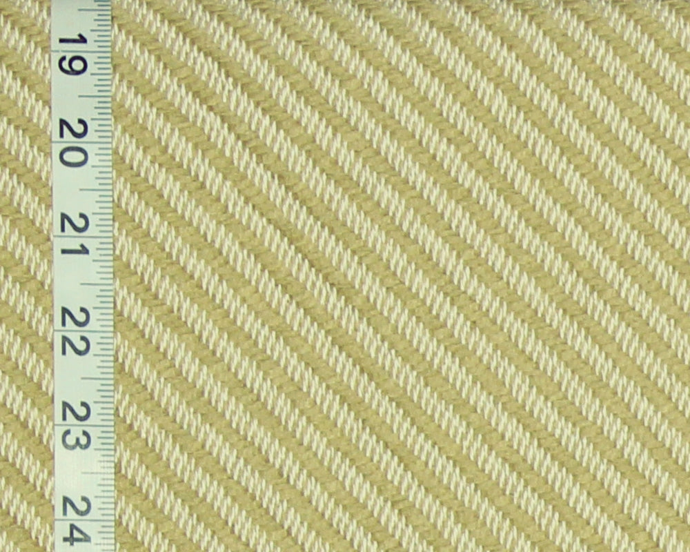 A close-up of a woven fabric texture in pale yellow and off-white, with a white measuring tape running vertically along the left edge for scale.