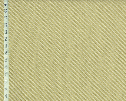 A close-up of a woven fabric texture in a pale warm yellow-beige color, with a measuring ruler visible along the left edge for scale.