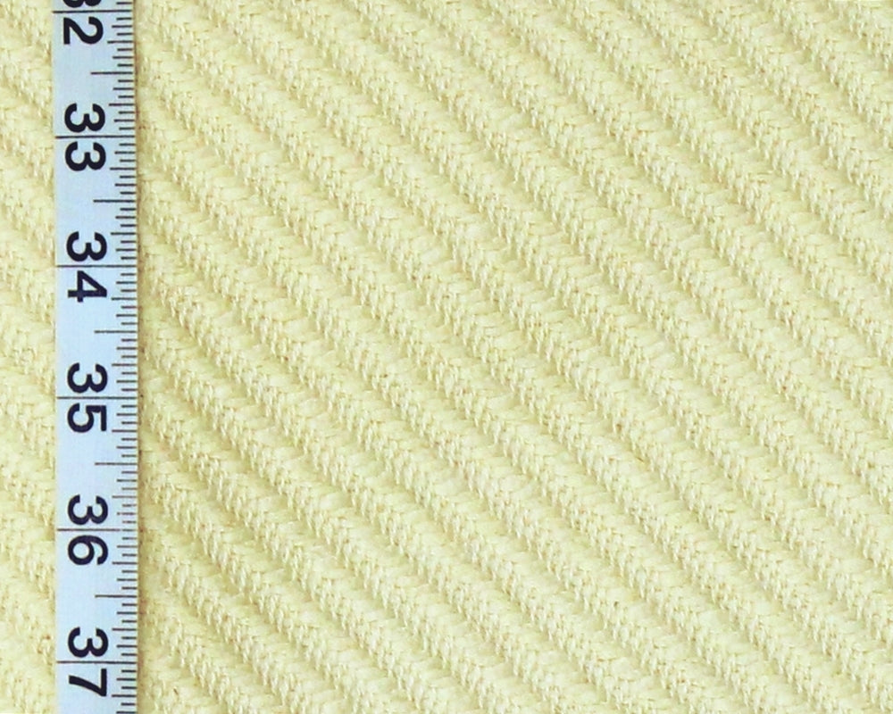 Close-up of a pale yellow ribbed fabric texture with a white measuring ruler along the left edge for scale.