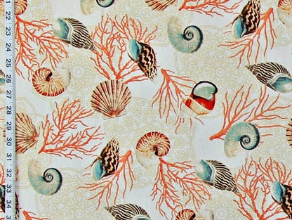 Seashell and coral pattern on fabric with a ruler for scale.
