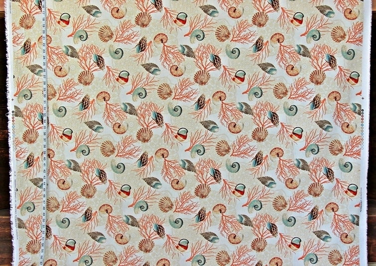 Patterned fabric with sea-themed design on a beige background