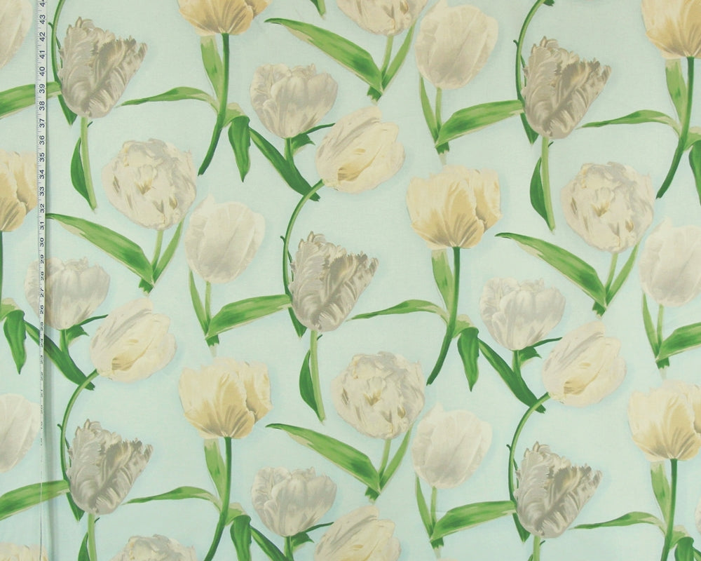 A close-up of a fabric or wallpaper pattern featuring watercolor-style tulips in cream, beige, and light gray with green stems on a pale mint-green background. A ruler is visible along the left edge for scale.