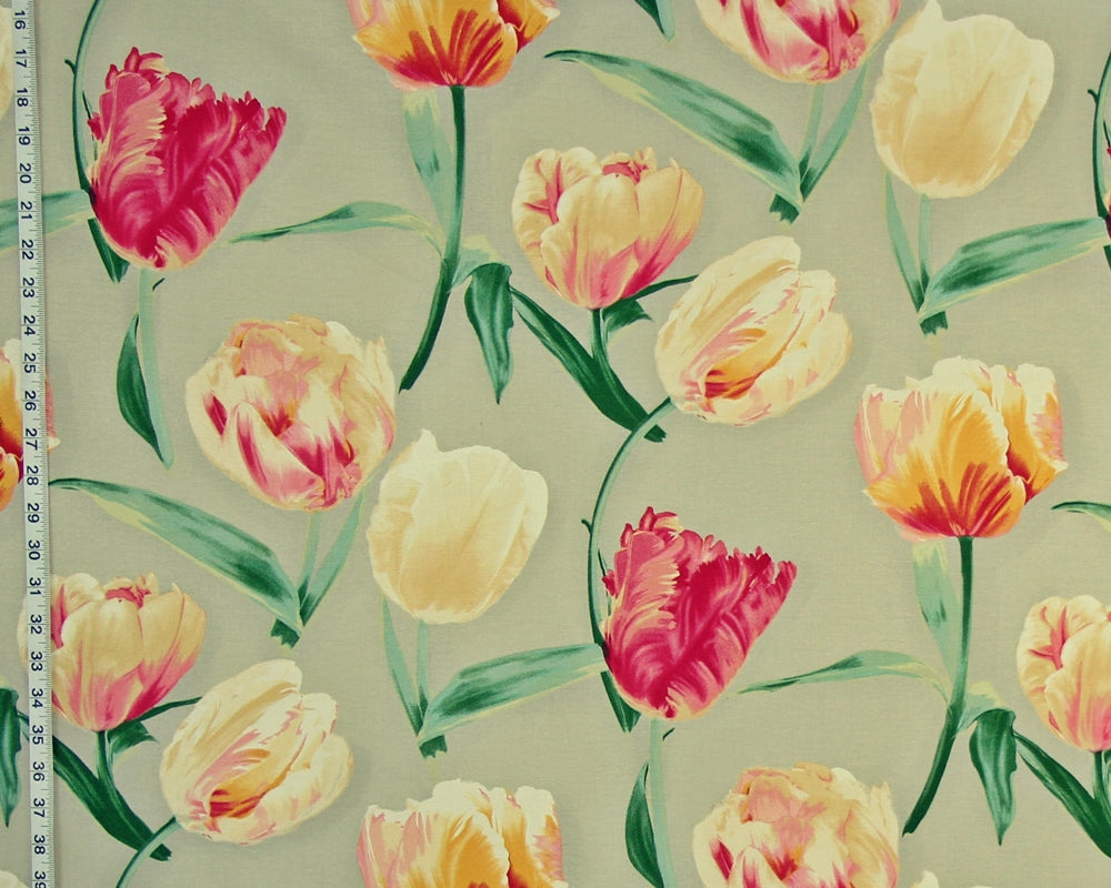 A close-up of a floral pattern featuring tulips in yellow, pink, and cream on a light sage green background, with a ruler visible along the left edge for scale.