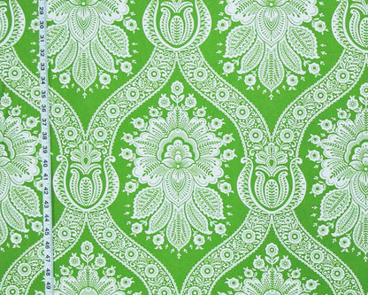 Green and white damask patterned fabric with a vertical measuring tape visible on the left side.