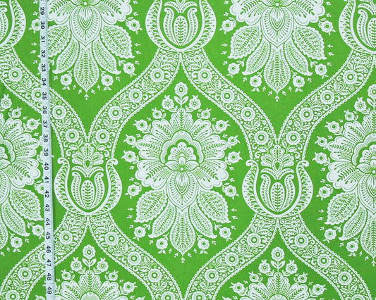 Green and white damask patterned fabric with a vertical measuring tape visible on the left side.