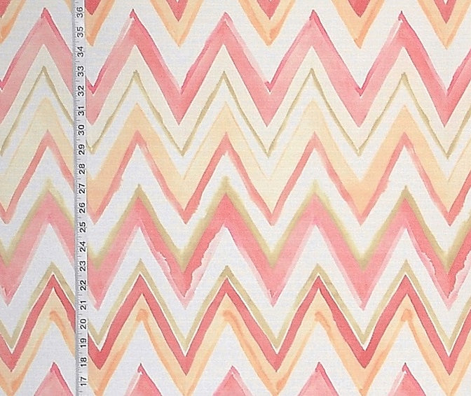 Fabric with pink and beige zigzag pattern and a ruler for scale.