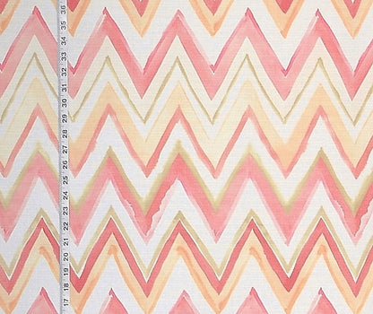 Fabric with pink and beige zigzag pattern and a ruler for scale.