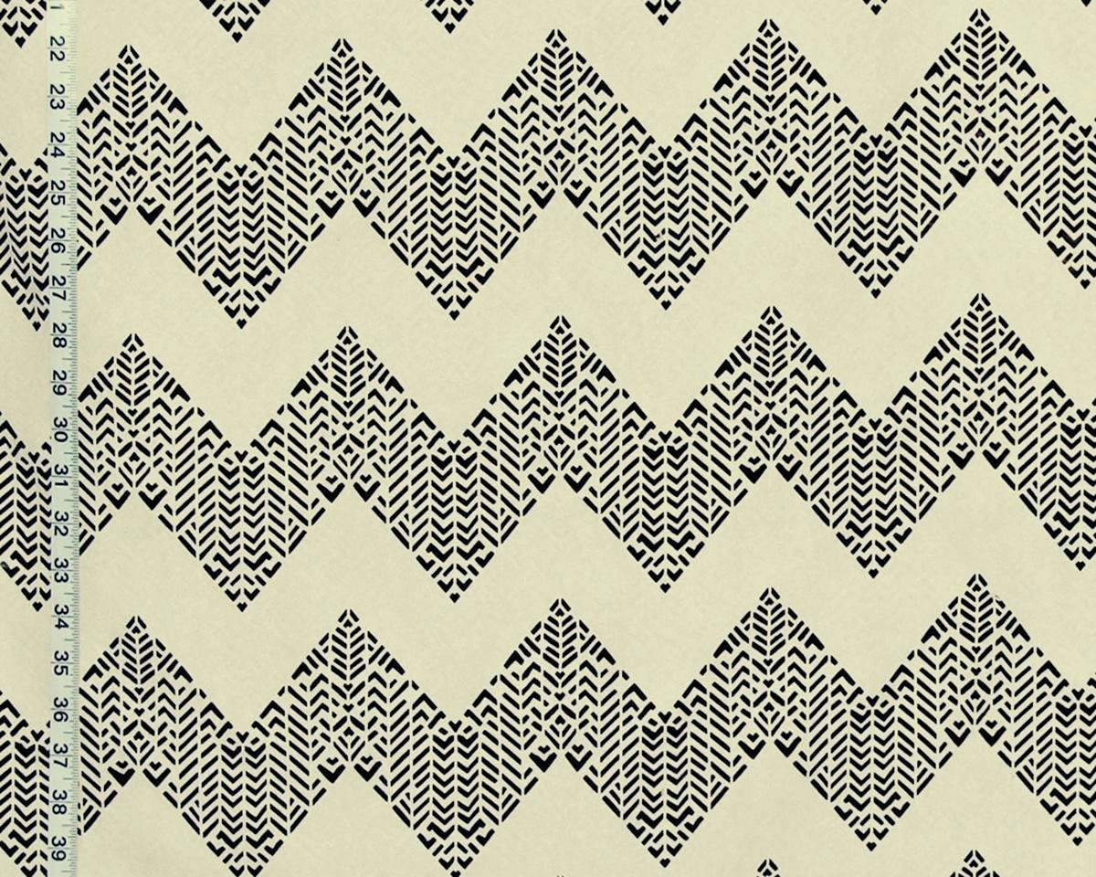 Black and cream zigzag patterned fabric with a small black ruler visible along the left edge for scale.