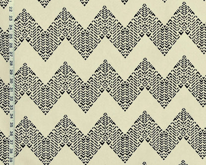 Black and cream zigzag patterned fabric with a small black ruler visible along the left edge for scale.