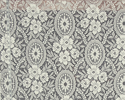 A close-up of a lace fabric with an intricate floral and medallion pattern in cream and gray.