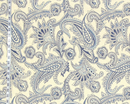 Blue paisley pattern on a beige background with a ruler for scale.