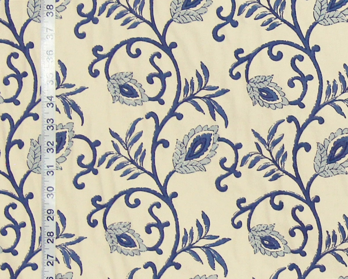 Blue floral pattern on beige fabric with a ruler for scale